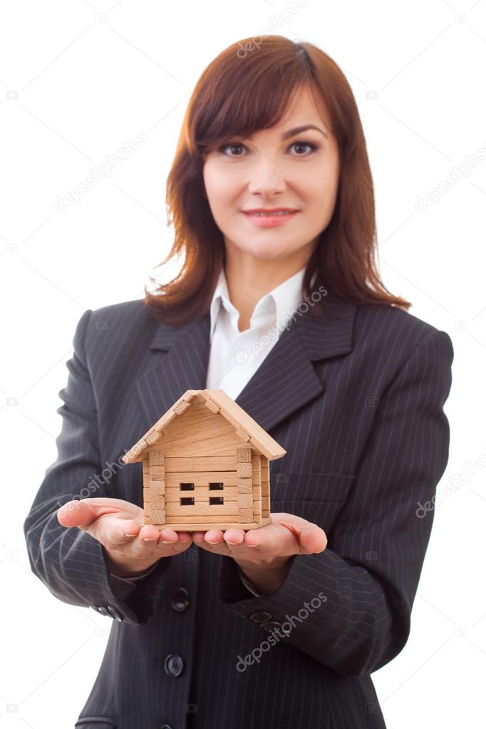 adult realtor with wooden toy house,it could be the tenant too. All isolated on white background.