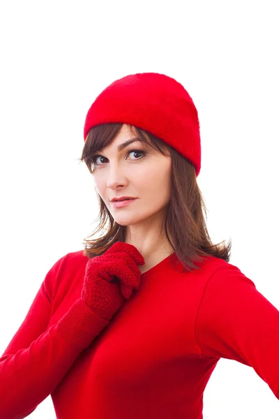 Ernstes Wintermädchen mit rotem Hut, Fäustlinge auf weißem Hintergrund — Stockfoto