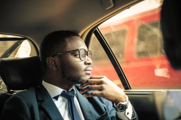 Businessman in a taxi — Stock Photo, Image