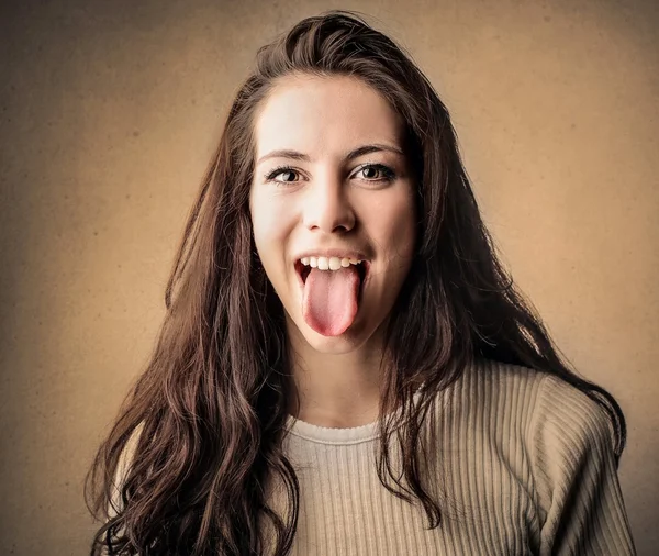 Woman showing her tongue — Stock Photo, Image