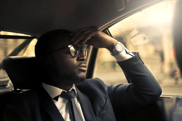 Businessman inside a taxi — Stock Photo, Image