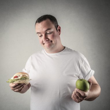 Chubby man deciding whether to eat healthy food or a hamburger clipart