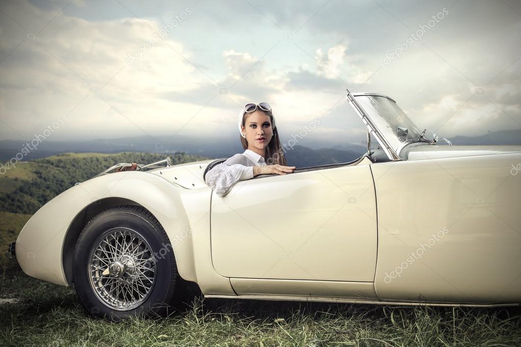 Classy woman in a vintage car