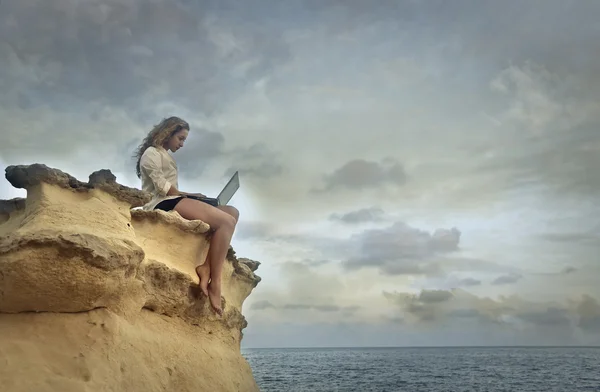 Sitting on a rock — Stock Photo, Image