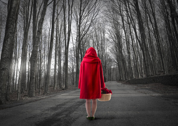 Woman walking through the forest with Red cap