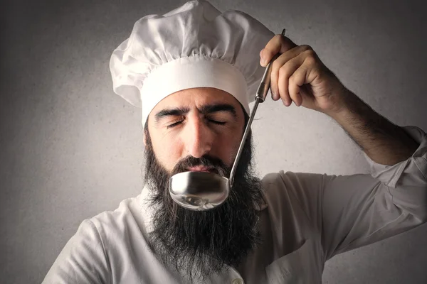 Cook savoring a meal — Stock Photo, Image