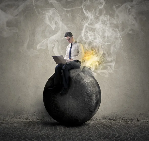 Businessman sitting on a bomb — Stock Photo, Image