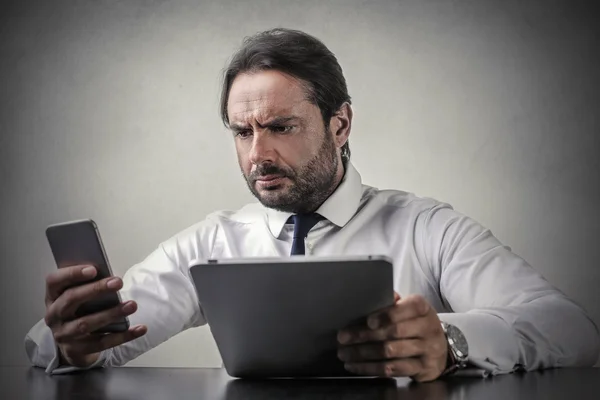 Businessman checking something out on his tablet — Stock Photo, Image