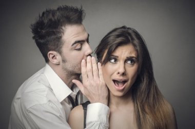 Man whispering secrets to a woman clipart