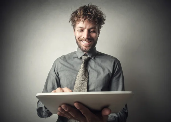 Homem de negócios sorrindo usando um tablet — Fotografia de Stock