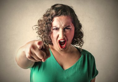 Angry woman pointing her finger towards someone clipart