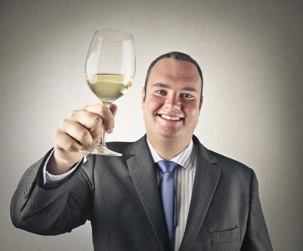 Businessman holding a glass of wine — Stock Photo, Image