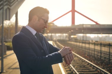 Businessman waiting for the train clipart