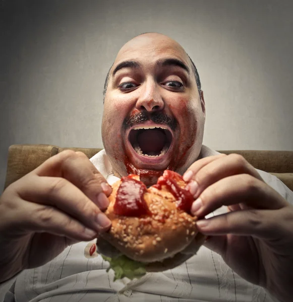 Comer o hambúrguer Imagem De Stock