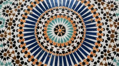 Marakeş, Fas 'taki bir fıskiyenin geleneksel İslami geometrik tasarımında renkli zellige deseni. Çivit mavisi, safran, nane ve kohl renklerinden yapılmış. Kamera hareketi: dönüyor.