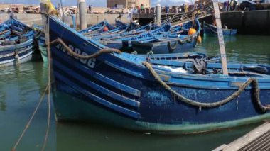 Essaouira limanında eski, ahşap, mavi balıkçı tekneleri suda sallanıyor. Balıkçılık endüstrisi. Turizm, Fas 'ta seyahat beldesi.