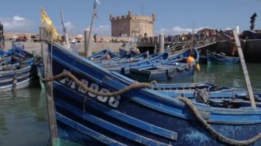 Essaouira limanında eski, ahşap, mavi balıkçı tekneleri suda sallanıyor. Balıkçılık endüstrisi. Turizm, Fas 'ta seyahat beldesi.