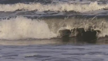 Clean water sea ocean waves in slow motion. Water texture, environmental conservation, climate change background footage, warm color tonality.