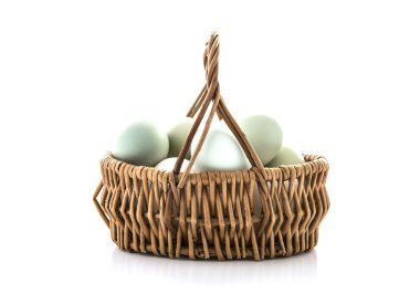 Bir hasır sepet beyaz zemin üzerine mavi yumurta
