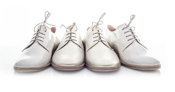 Four White Shoes on a White Background — Stock Photo, Image