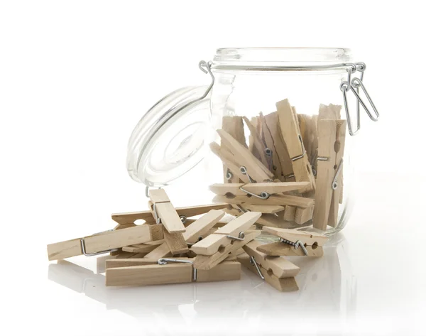 Wooden clothes pegs in a glass Jar — Stock Photo, Image