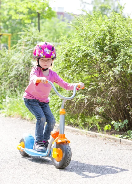 Little girl with a scooter — Stock Photo, Image