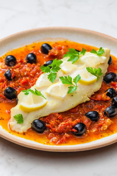 cod on tomato sauce with black olives