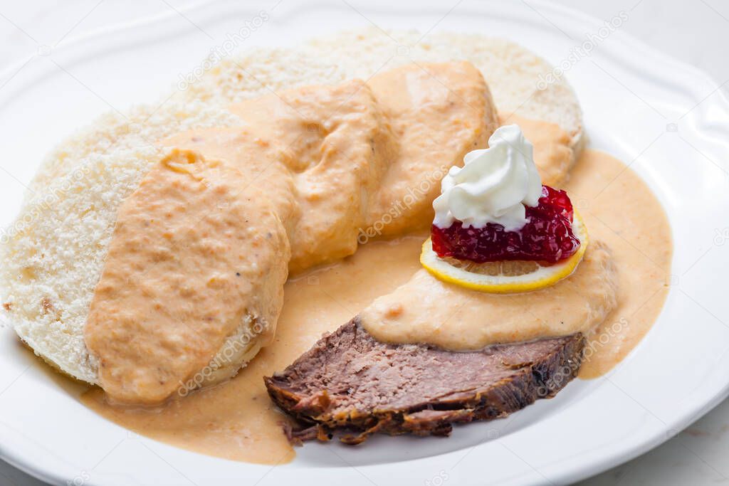 sirloin sauce with dumplings and cranberries on lemon with whipped cream