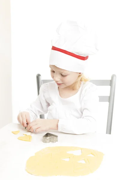 Little girl cutting cookies — Stock Photo, Image