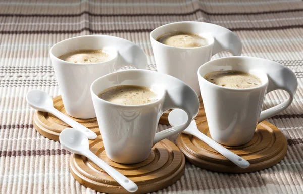 Cups of coffee on place mats — Stock Photo, Image