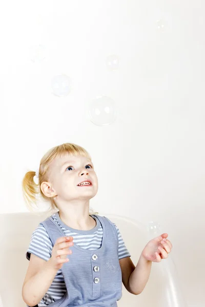 Little girl playing with bubbles — Stock Photo, Image