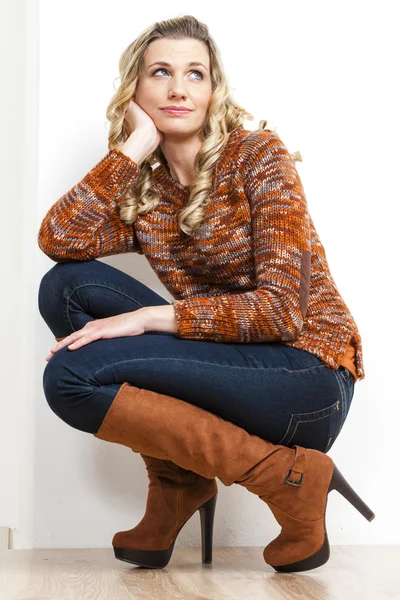 Sitting woman wearing fashionable brown boots — Stock Photo, Image