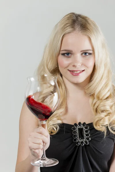 Portrait of young woman with a glass of red wine — Stock Photo, Image