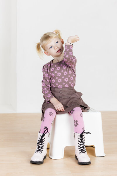 sitting little girl with a bracelet