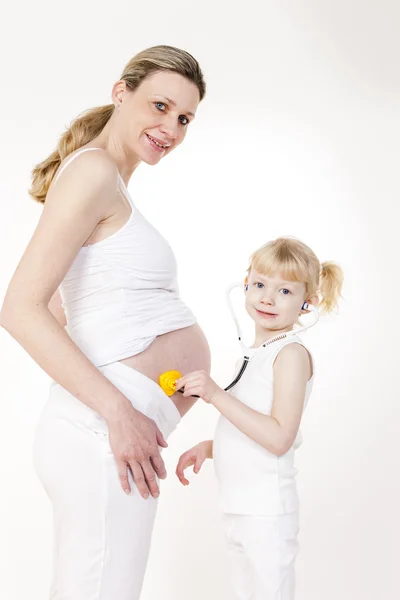 Menina cuidando depois de mãe grávida — Fotografia de Stock