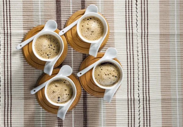 Cups of coffee on place mats — Stock Photo, Image