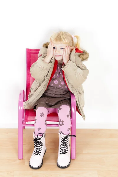 Little girl sitting on chair — Stock Photo, Image