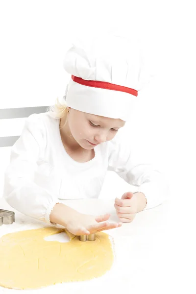 Little girl cutting cookies — Stock Photo, Image