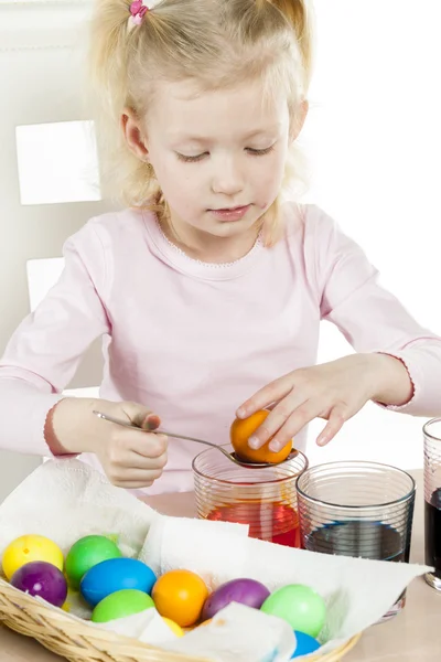 Portrait of little girl during Easter eggs' coloration — Stock Photo, Image