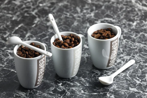 Coffee cups full of coffee beans — Stock Photo, Image