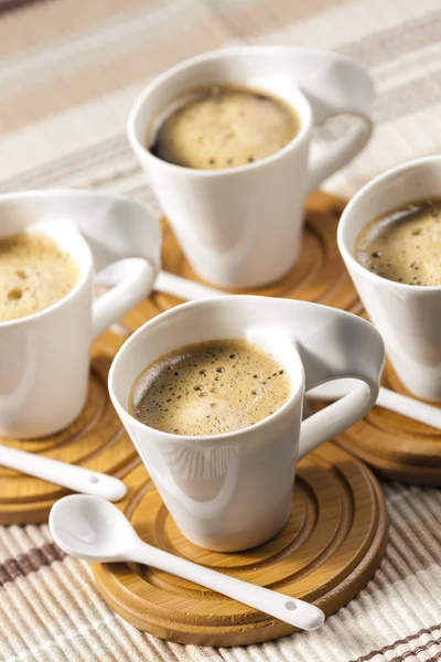 Cups of coffee on place mats — Stock Photo, Image