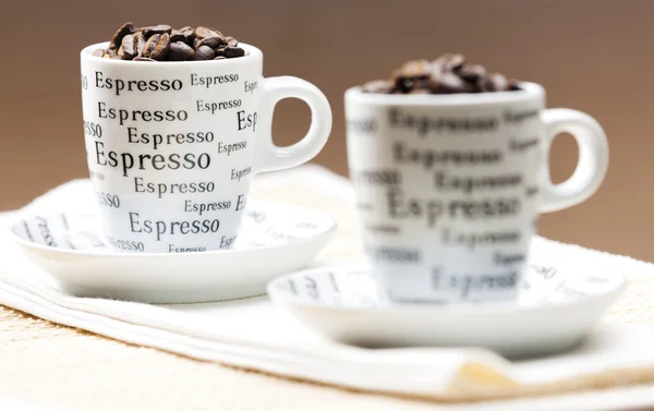 Káva poháry plné kávová zrna — Stock fotografie