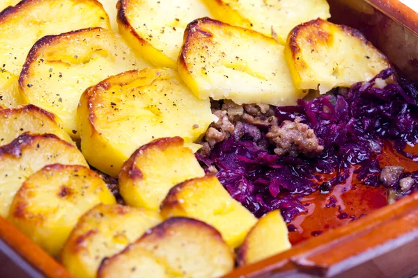 potatoes baked with pork minced meat and red cabbage