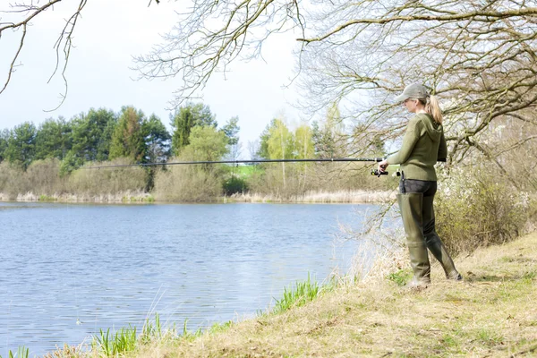 Woman fishing at pond in spring — Stock Photo, Image