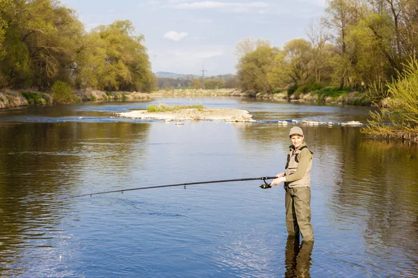 Mujer pescando en el río en primavera —  Fotos de Stock