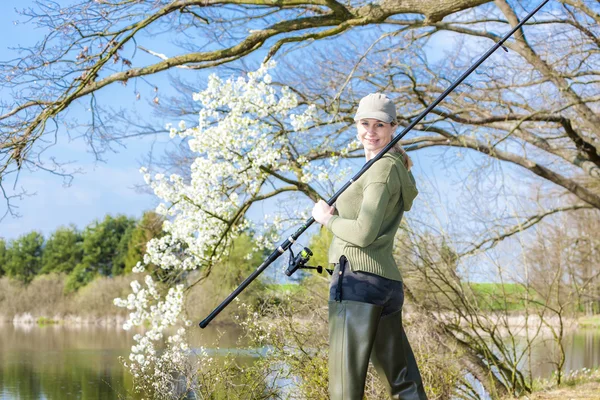 Woman fishing at pond in spring — Stock Photo, Image