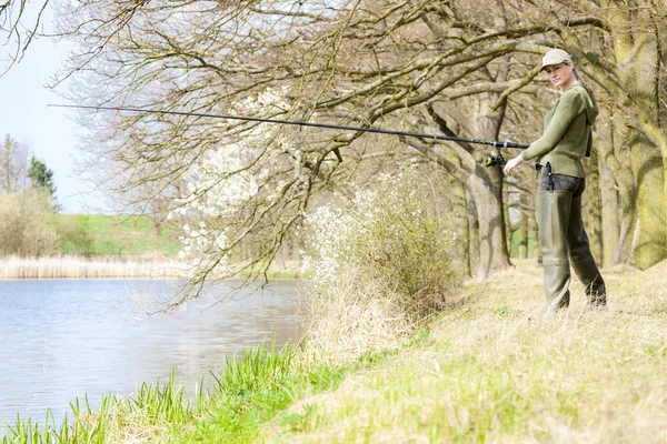 Woman fishing at pond in spring — Stock Photo, Image