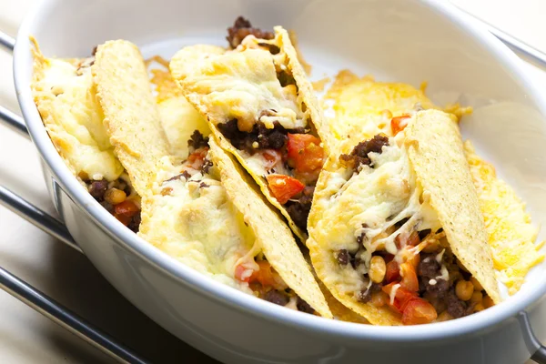 Baked tacos filled with minced beef meat, beans and tomatoes — Stock Photo, Image