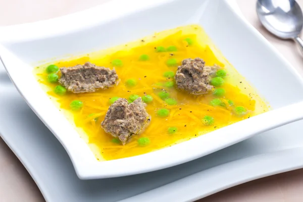 Homemade liver dumplings in chicken soup with carrots and peas — Stock Image Homemade liver dumplings in chicken soup with carrots and peas Stock Image