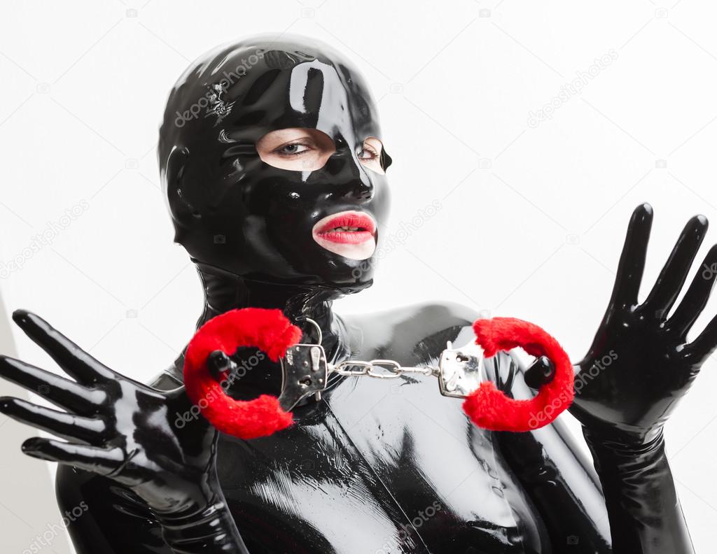 portrait of woman wearing latex clothes with handcuffs
